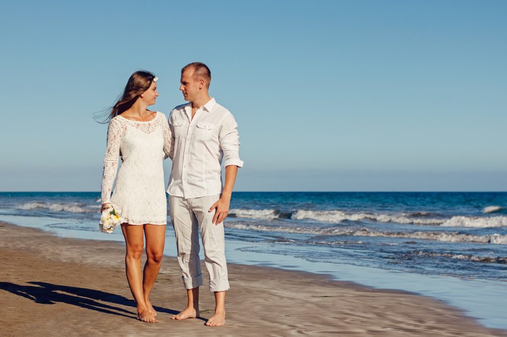 Happy couple walking on the beach