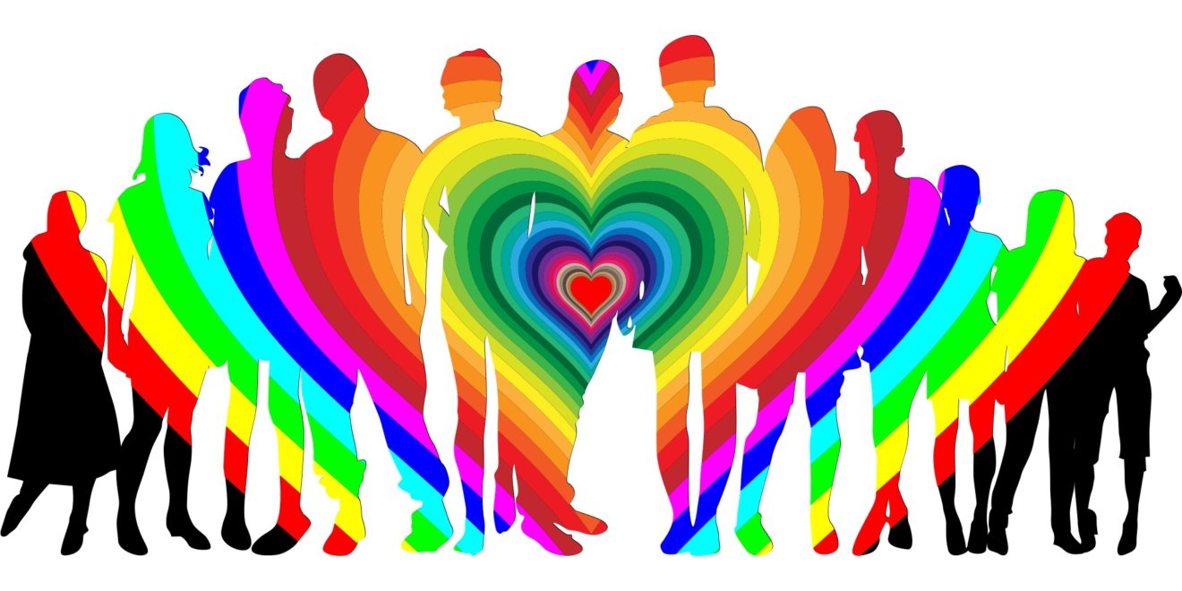 A row of 12 people in rainbow colors