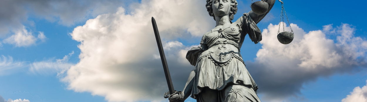 Statue of Justice against clouds